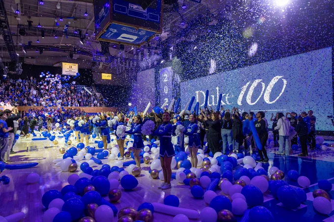 Balloons and confetti cover the floor of Cameron as students and staff cheer