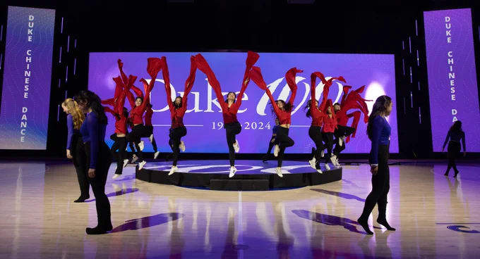 Duke Chinese Dance takes the stage. Red scarves float around the performers
