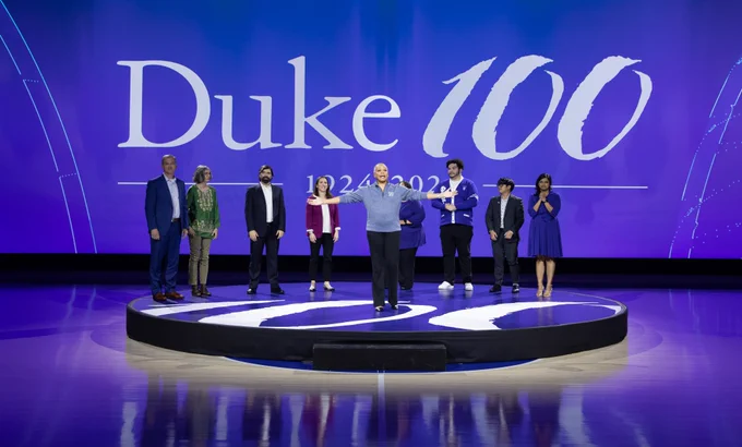 Centennial host Lisa Borders stands with her arms outstretched in front of the other speakers at the event