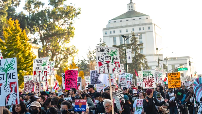 A sea of protesters holding signs stating "Labor For Palestine" and "Ceasefire."