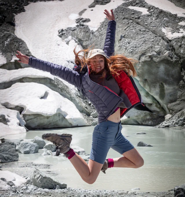 Student jumping in the air with excitement because she is a Geography student at the University of Worcester.