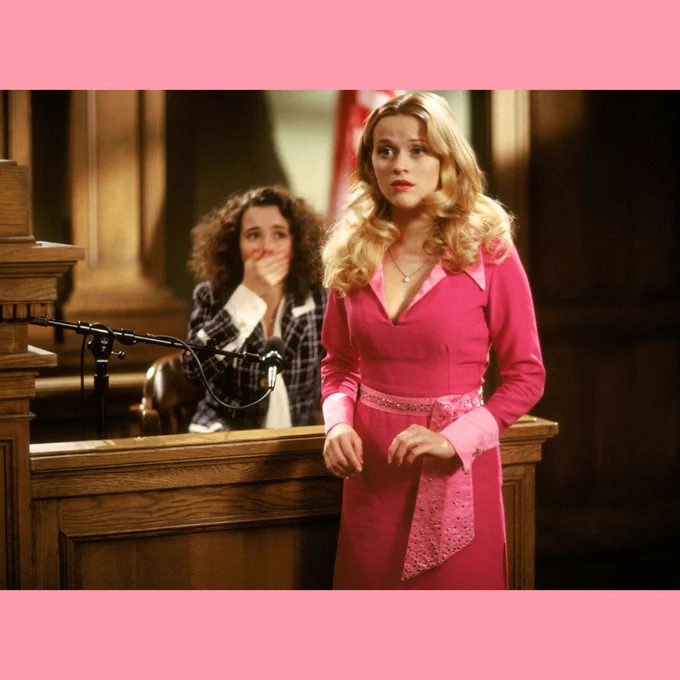 Image is a still from the movie legally blonde. It shows the moment that Elle Woods reveals who has truly done the crime. In the background is Chutney on the stand looking shocked.