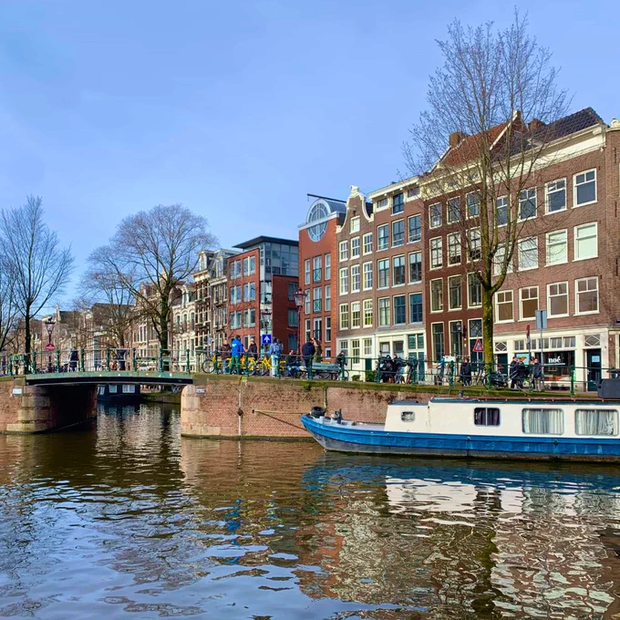 Amsterdam canal with houses in background