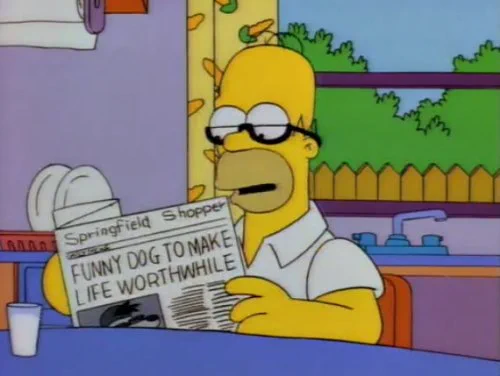 Homer Simpson, wearing his tiny reading glasses