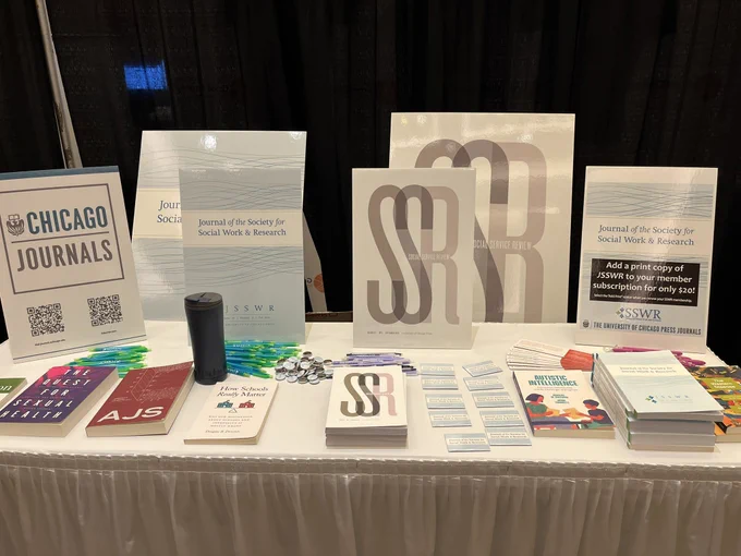 Display table featuring copies of UChicago Press Journals, including Social Service Review