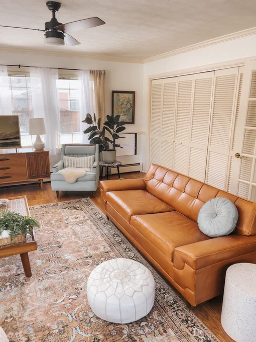 A tastefully designed living room with a modern aesthetic, complete with a MinusA2 air purifier, leather sofa, and chic home accessories, all highlighted by the creative touch of @dreamgreendiy.