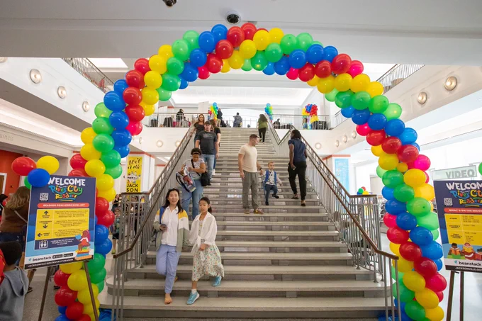 Rainbow balloons in an arc over stairs