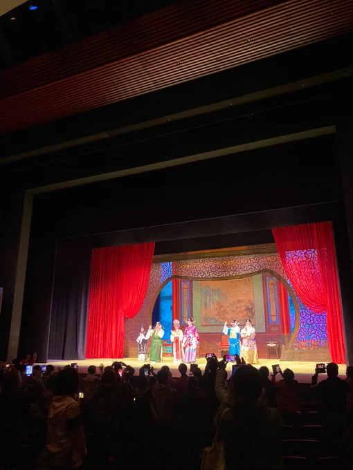 Performers onstage in traditional Cantonese Opera costumes.