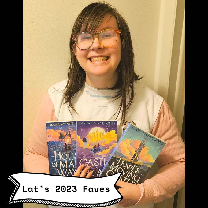 Lat holds the Howl’s Moving Castle trilogy, smiling.  
