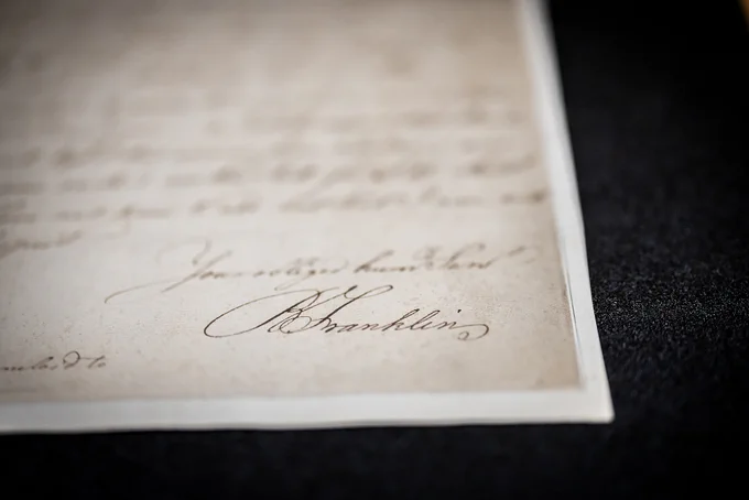 Close up of Benjamin Franklin's signature on a handwritten document.