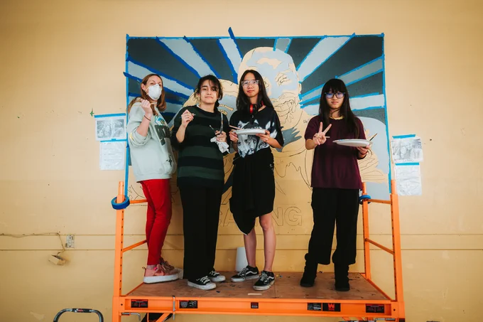 students painting a mural