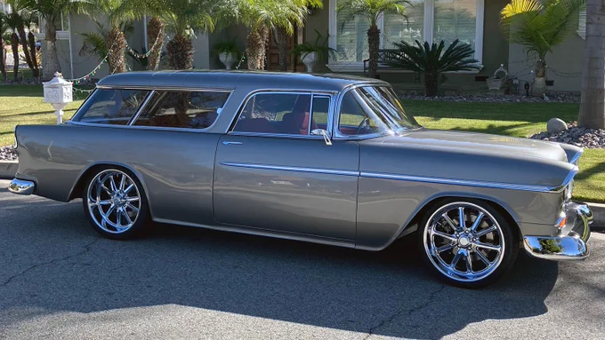 Lot #1321.1 - This custom 1955 Chevrolet Nomad received a frame-off, rotisserie-restoration by Denny's Bowtie Restoration that took 2 years to complete. The Van Nuys-built Southern California body was placed on a rotisserie, stripped, then metal-finished, with several coats of DTM applied and blocked. Four coats of PPG Greystone Metallic and then five coats of House of Kolor show clear were used, then cut and buffed. This Nomad is powered by a Texas Speed Billet LS engine with dual billet TorqStorm superchargers producing 1,125hp, presently tuned to 750hp for street use. It is equipped with a custom stainless exhaust with Bassani stainless mufflers, wastegate adjustment Mad Dog special-programmed 4L70E automatic transmission, Inland Empire 3.5-inch aluminum driveshaft and Strange Truetrac differential on an Art Morrison GT chassis with RideTech air-ride suspension. Stopping power comes from Wilwood hydro-boost front and rear big brakes