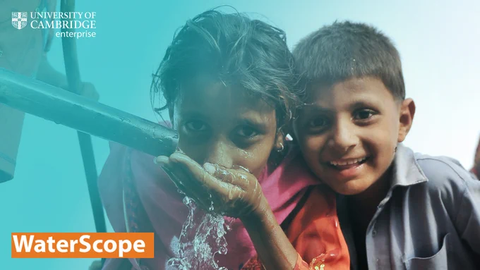 Image of a two children, one female on the left, male on the right. They are both looking at the camera, smiling. The girl is drinking clean water from a pipe. Overlaid on the image is a blue gradient filter. In the top left corner is the University of Cambridge Enterprise logo. At the bottom left corner is a title, white text on a teal blue background, that reads "WaterScope". 