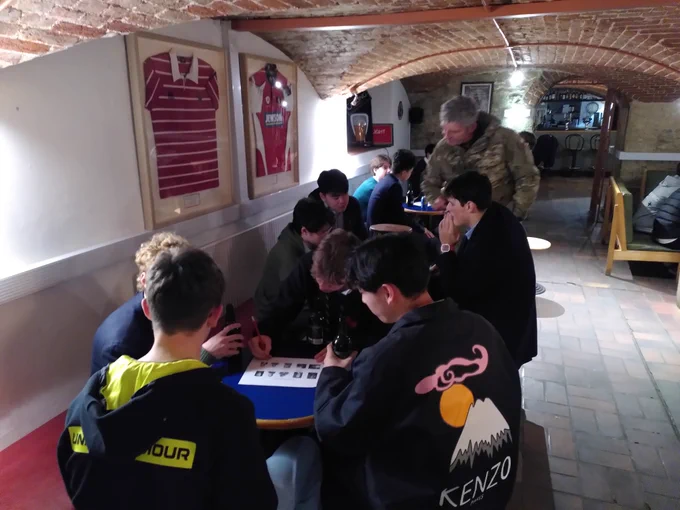 Boys sat at tables puzzling over quiz questions