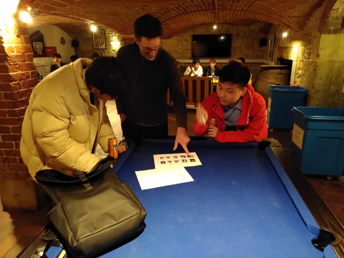 A teacher helping a little with a picture round