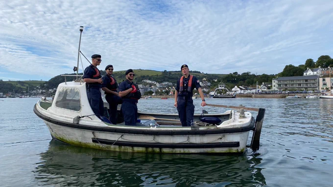 Four Officer Cadets in a small boat 