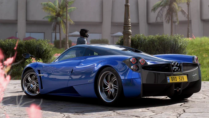 A 2012 Pagani Huyara finished in my first draft interpretation Blu Argentina parked at the gardens at the Palacio Azul del Oceano Hotel in Forza Horizon 5.