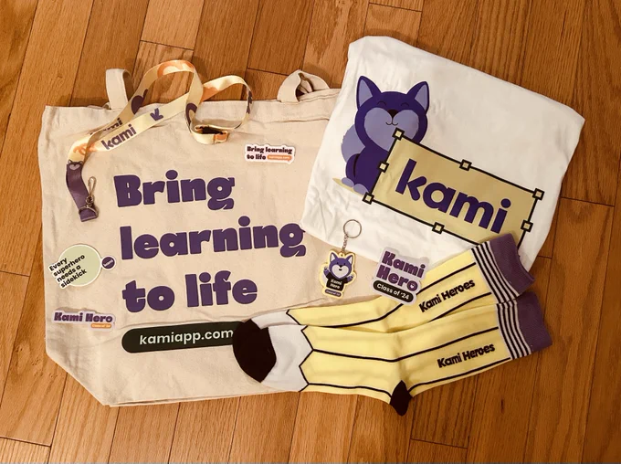 Swag received from Kami, including:
canvas tote bag that says "bring learning to life"
t-shirt that says Kami with their logo
keychain with Kami logo that reads "Kami Hero Class of '24"
socks with a pencil pattern that say "Kami Heroes"
Kami lanyard
various Kami stickers