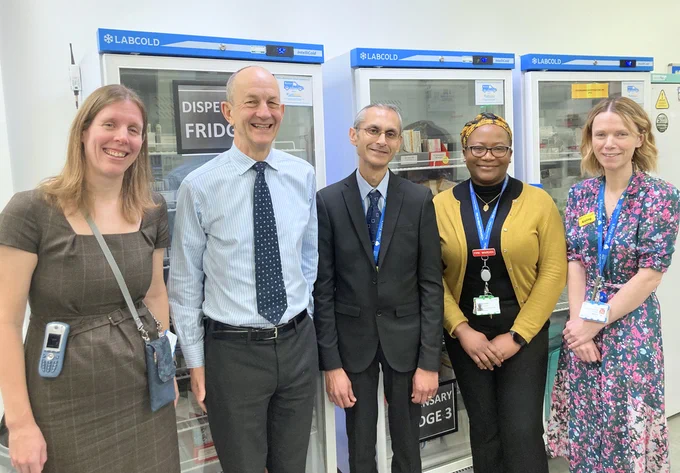 Image of Chris Dulwich, Medical Director at NHS England London visiting King's College London Pharmacy team along with staff at King's.