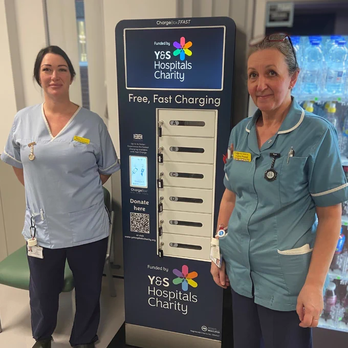 Two nurses standing by the ChargeBox charging unit