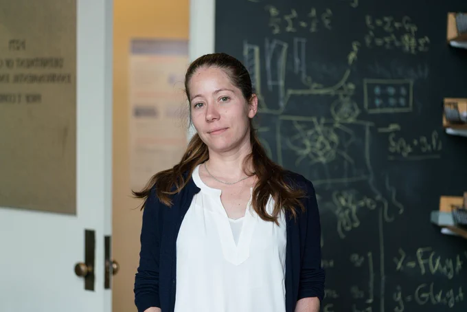 Headshot of Tal Cohen with a chalkboard in the background.