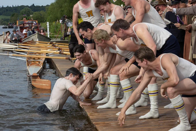 Shot on the Thames towpath, rowers during the film lift someone out of the river surrounded by crowds