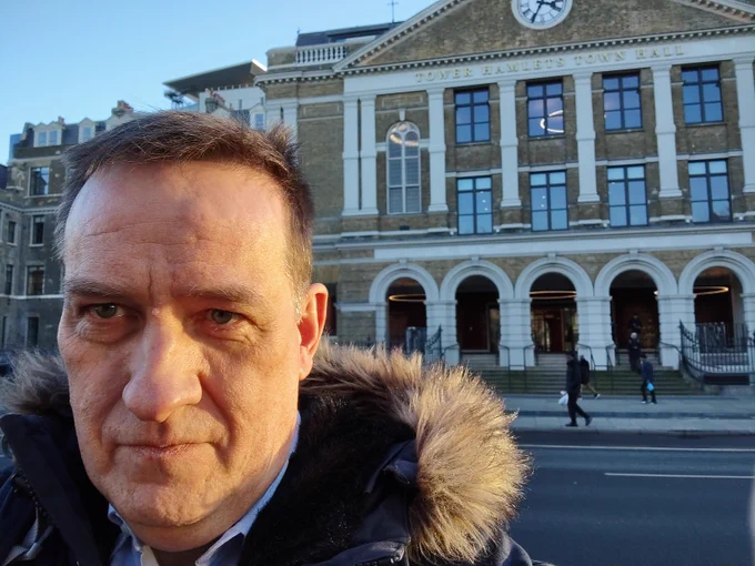 White man standing in front of Tower Hamlets Town Hall