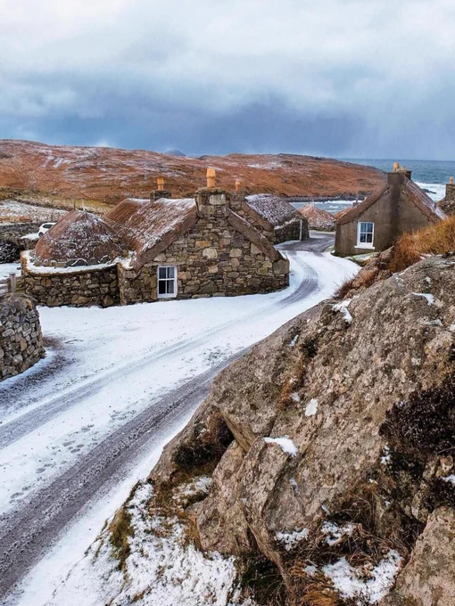 snow covered houses in a coastal village
