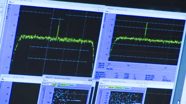 Photo of screens at mission control showing the signal from a wide awake Rosetta.