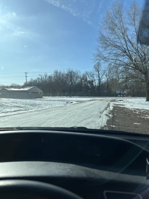 Photo of icy road out the front window of a car