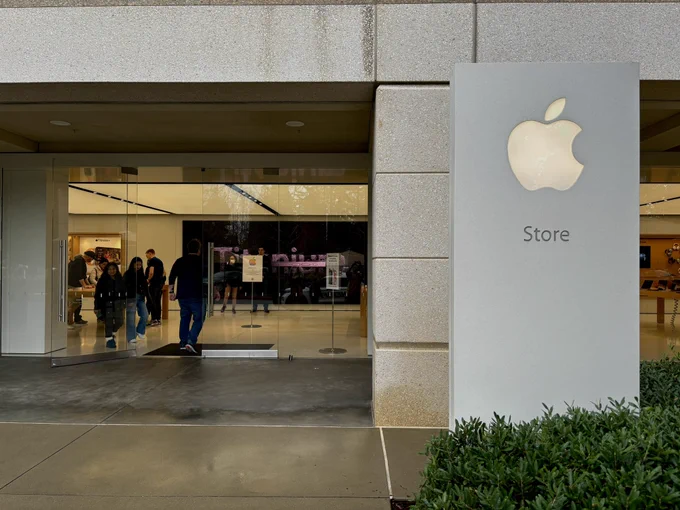 An exterior photo of the Apple store at Infinite Loop. The weather is gray and rainy.