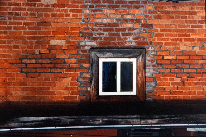 White framed window in a brick wall. Garner North Carolina, USA. First time using the new Harmon Phoenix 200 ISO film.  Shot at EI 125.  NikonFM2, Nikon Series E 28, 50, & 135mm lenses.  