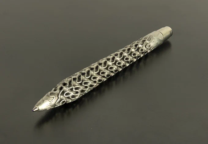 3d printed pen in stainless steel featuring complex gyroid lattice structure, DMLS technology