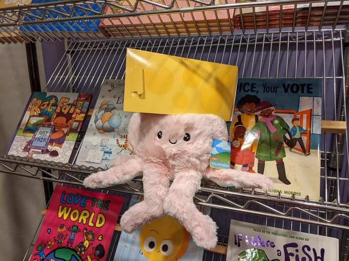 Olive the octopus being silly and posing with a cheese hat