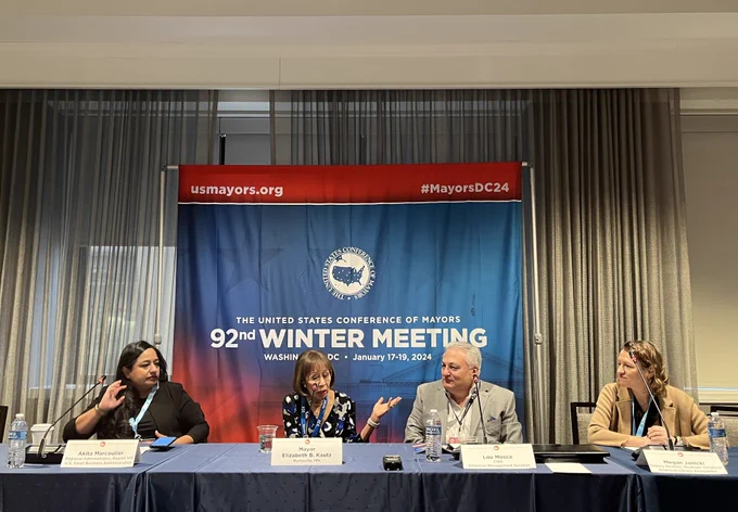 Picture of a roundtable presentation at the US Conference of Mayors 92nd Winter Meeting in Washington, DC in January 2024. From left to right on the panel: Akita Marcoulier, the Regional Administrator, Region VIII, US Small Business Admin.; Mayor Elizabeth B. Kautz of Burnsville, MN; Lou Mosca, COO of American Management Services; and Megan Janicki, Deputy Director of Strategic Initiatives at the American Library Association. 
