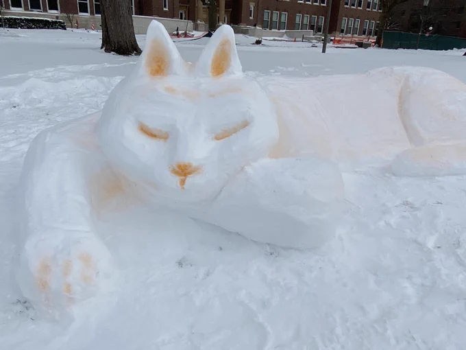 snow sculpture of a sleeping cat