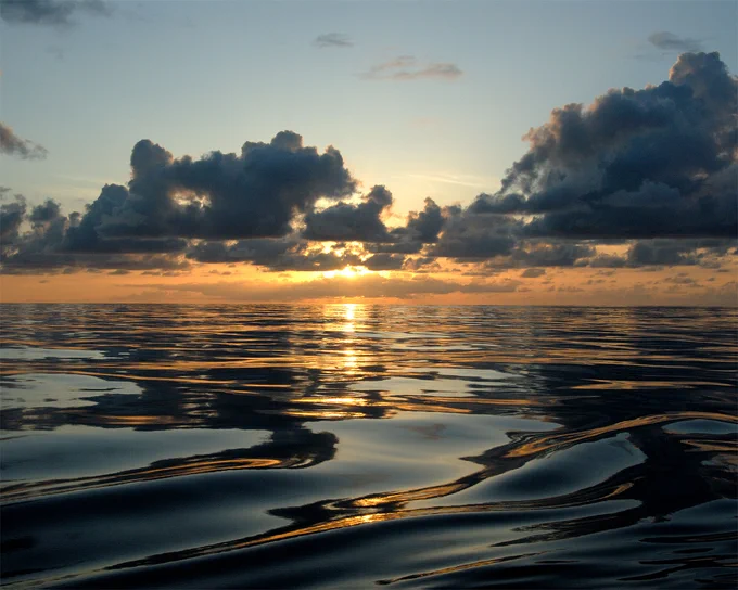 A sunset viewed from Kure Atoll, located near Midway Atoll in the Northwestern Hawaiian Islands. An atoll is an island of coral that encircles a lagoon partially or completely. Photo credit: NOAA’s National Ocean Service 