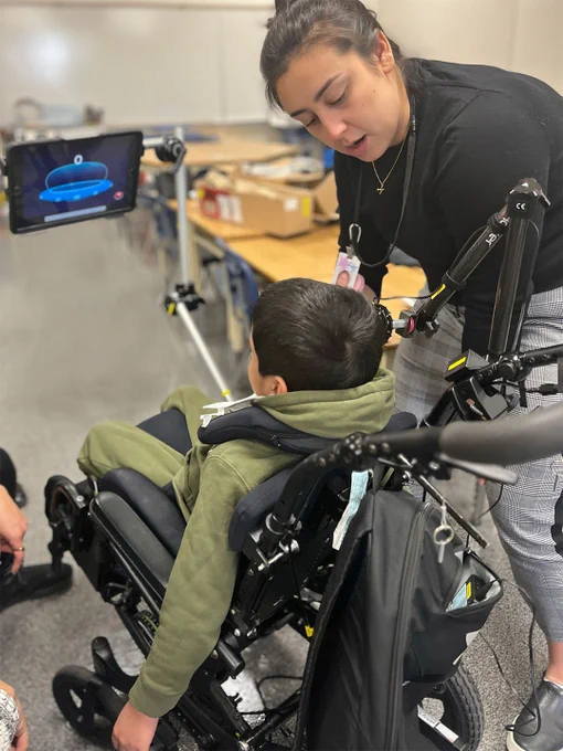 Tessa attaches mount to student's wheelchair.