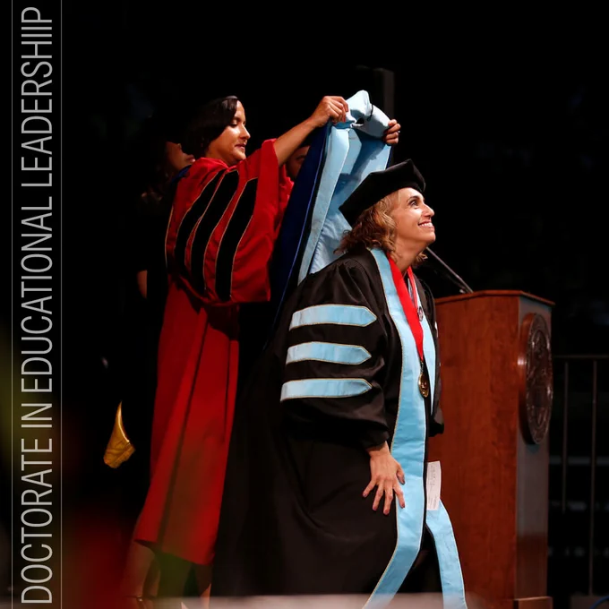 Doctoral student getting hooded at the graduation ceremony