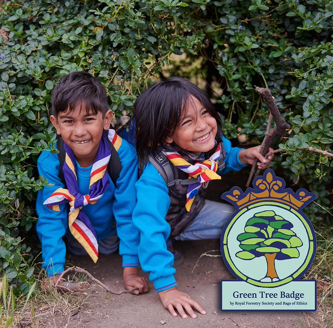 Two young people outside with an overlay of the Green Tree Badge
