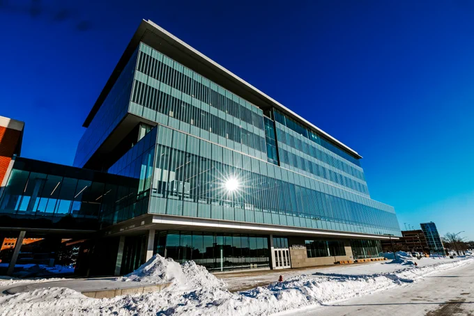 The exterior of Kiewit Hall, a six-story building featuring tall glass windows