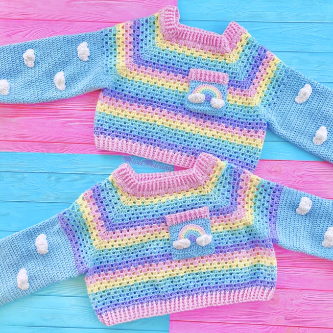 2 cropped pastel rainbow striped crochet sweaters with a rainbow and cloud chest pocket and blue sleeves with a cloud pattern on them