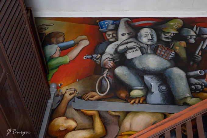 Part of the mural shows fascist powers like the KKK being fought by the people