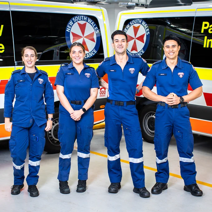 Ambulance Australia Season 5 on 10 and 10 Play. Paramedics Ash, Keely, Paul, Jason standing in front of two ambulances. 