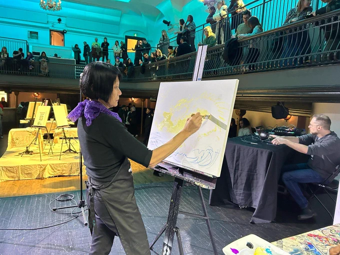 Mayor Olivia Chow starts on her painting.