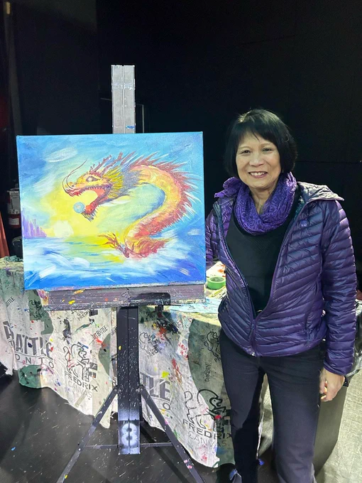 Mayor Olivia Chow shows off her final painting. The painting is of a dragon and a pearl, as is common in Chinese art.
