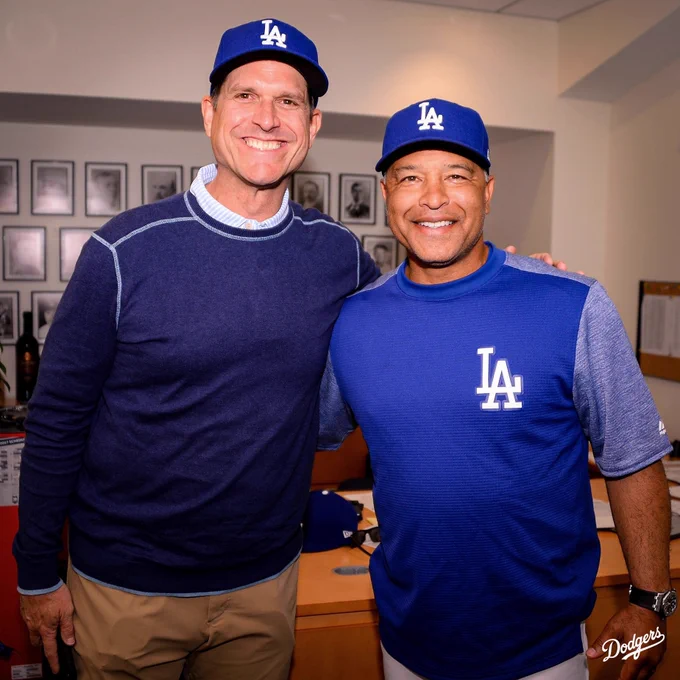 Coach Harbaugh and Dave Roberts pose for a photo in Doc’s office.