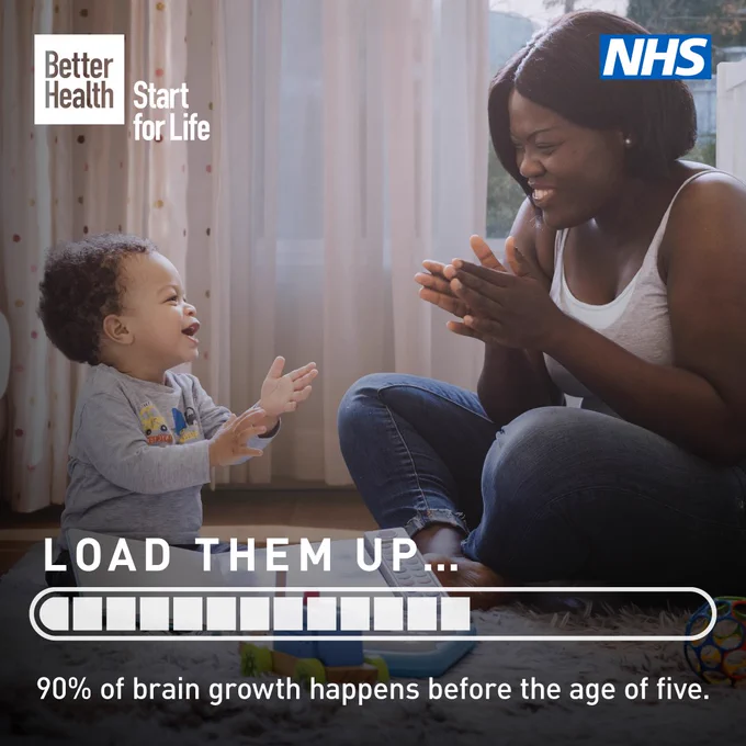 A visual of a woman and her infant child face each other while clapping and smiling.