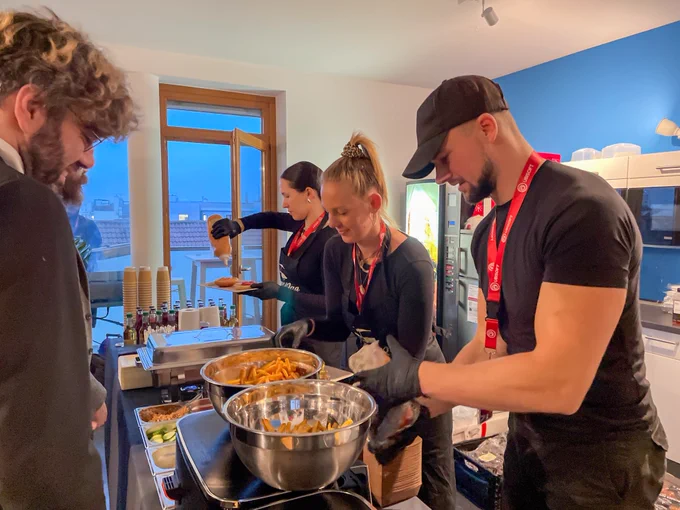 Our team members choosing what they want from the catering options, different burger toppings, sauces and fries.