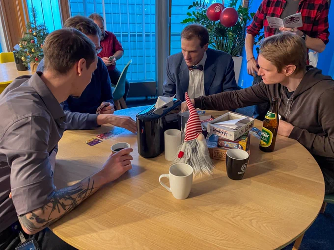 Our team member sitting around a round table playing card games.